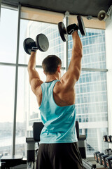 Close up of man using dumbbell exercise at gym, Sport concept