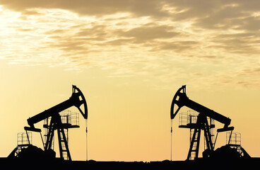 Oil drilling derricks at desert oilfield. Crude oil production from the ground. Oilfield services...
