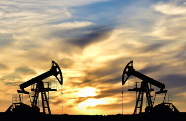Oil drilling derricks at desert oilfield. Crude oil production from the ground. Oilfield services...