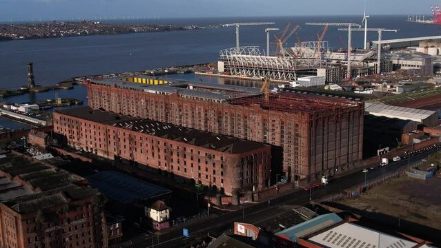 Drone Aerial of Stanley Dock Tobacco Warehouse with Everton Football Club new Waterfront Stadium
