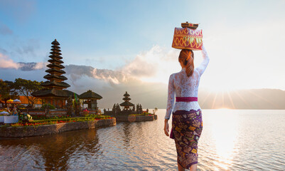 Balinese girl in traditional costume - Pura Ulun Danu Bratan temple - Hindu temple on Bratan lake -...