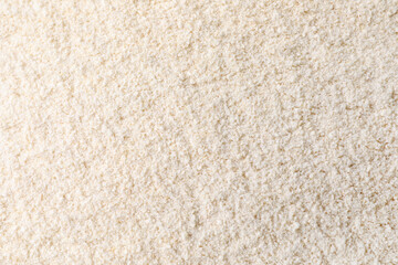 Fototapeta na wymiar Heap of quinoa flour as background, closeup