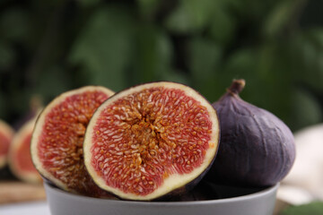 Tasty ripe figs against blurred background, closeup