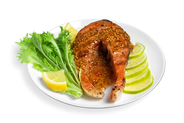 Tasty salmon steak with sauce, citrus slices and lettuce on white background