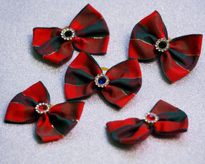 ive Christmas red and green dog bows lie on a shiny gray background.  accessories for dogs with long hair