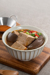 Spicy duck blood jelly soup and stinky tofu with scallion and chili pepper topping.