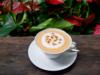 Cappuccino coffee in a white cup on the table