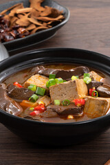 Spicy duck blood jelly soup and stinky tofu with scallion and chili pepper topping.