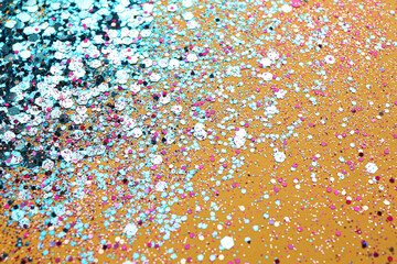 Shiny bright light blue glitter on yellow background