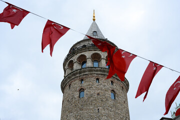 (Selective focus, focus on the Tower) Blurred Turkish National Flags in the foreground with the...