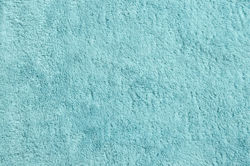 Obraz premium Soft light blue towel as background, top view