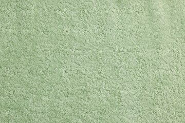 Soft pale olive towel as background, top view