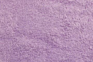 Soft pale purple towel as background, top view