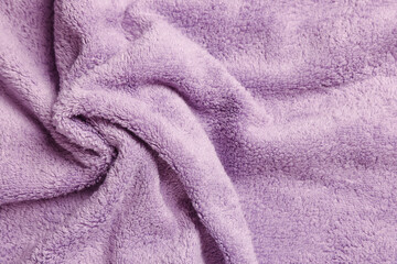 Fototapeta na wymiar Soft crumpled pale purple towel as background, top view