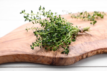 Bunch of aromatic thyme on white wooden table, closeup. Fresh herb