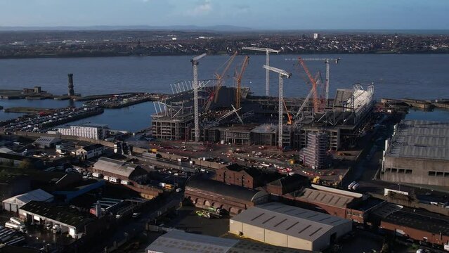 Aerial Drone Panning shot of Everton Football Club new Waterfront Stadium, Welsh Mountains in the distance