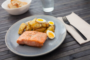 steamed salmon fillet with potato wedges and quail egg