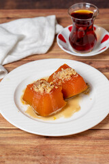 Zucchini dessert with tahini. Traditional Turkish cuisine delicacies. Local name tahinli kabak tatlisi. close up