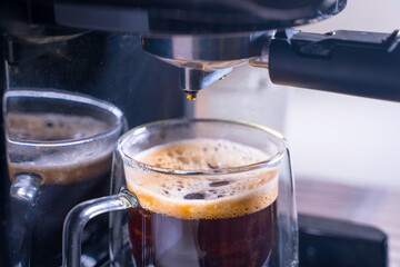 close-up of Coffee foam. espresso crema comes out of the fully automatic coffee machine, Making the coffee machine into a cup