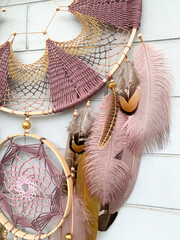 Close up pheasant feathers dream catcher bohemian wall hanging craft outdoors