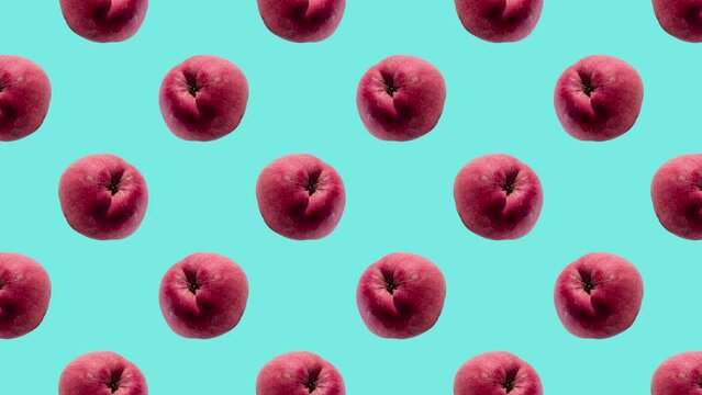 Red apples in geometric grid in seamless loop pattern on a coral background. Exotic fruits in seamless loop animation. Endless food motion graphic background