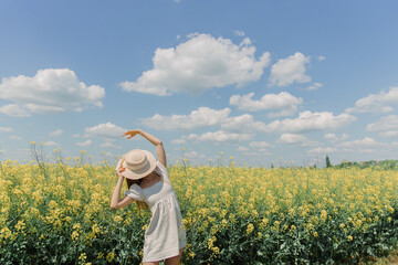 woman in a field wiht hat  on her face