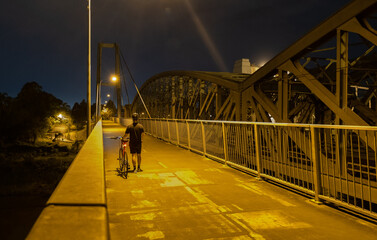 people on the bridge at night
