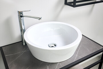 Interior of bathroom with washbasin and faucet. Bathroom interior sink with stoneware countertop modern flat minimalistic design.
