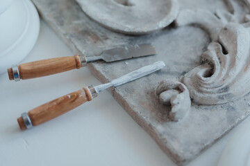 Shot of workplace of sculptor there are stacks and marble art works.