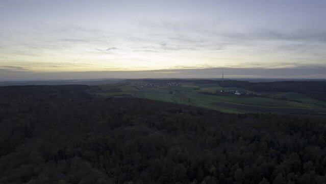 Forests and meadows of Swabian Jura at late evening dusk aerial time lapse