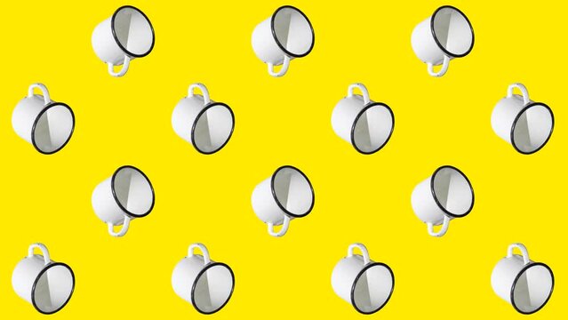 White enamel mugs on a yellow background. Simple travel animation concept with white mugs