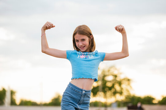 The very happy girl showing her strong arms.