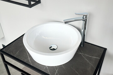 Interior of bathroom with washbasin and faucet. Bathroom interior sink with stoneware countertop modern flat minimalistic design.