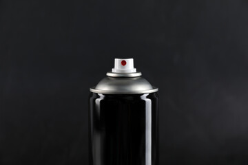 Can of spray paint on black background, closeup