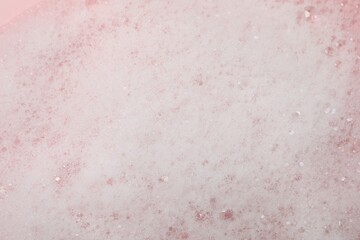 Fluffy soap foam on pink background, closeup - obrazy, fototapety, plakaty