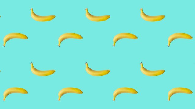 Seamless loop pattern with Bananas on a pale blue background. Exotic fruits in seamless loop animation. Endless food motion graphic background