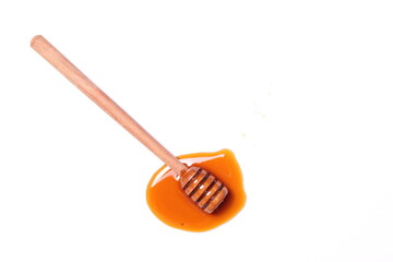 Honey dripping from the dripper on a white background, top view