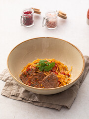 Portion of gourmet spaghetti pasta arrabbiata with roast beef