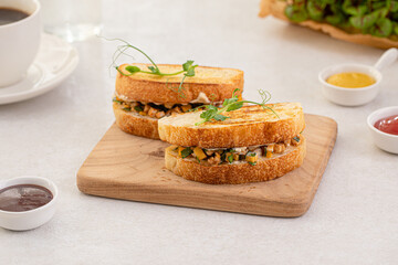 Portion of appetizing tuna sandwich with corn and herbs