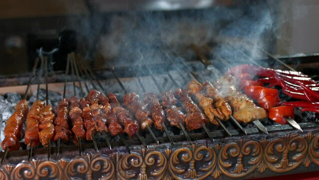 Making of Traditional Turkish meal kebab on barbeque.