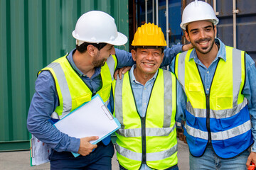Happy multiethnic professional engineers teamwork smiling and laughing together. Worker team's achievements and happiness at work