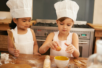 Children bake in kitchen for learning and development of baker skill, fun with baking ingredients and chef hat with apron. Childhood, focus and girl kids making cookies, diversity and work together.