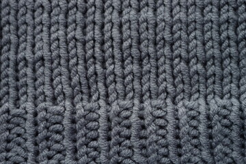 Knitted grey background, gray sweater cozy pattern