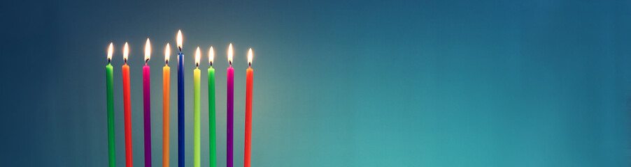 Image of jewish holiday Hanukkah with menorah (traditional candelabra) and colorful candles