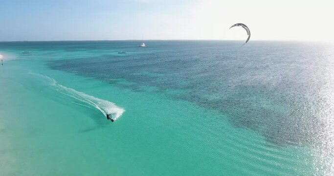 Man kitesurf sunset along coastline caribbean beach, aerial view Los Roques