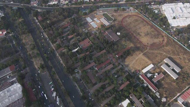 Aerial View Of Sports Track And Field Belonging To CCH Vallejo UNAM In Mexico City. Dolly Forward