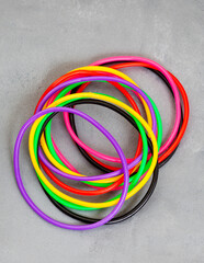 90’s rubber bracelets. 90’s trend, as many and as colorful as you can. On mottled gray