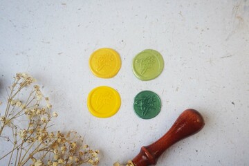 Pretty wax coins made from wax bead and stamp for a vintage look in letter or wedding invitation