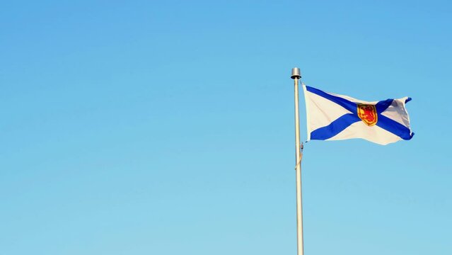 Waving Nova Scotia flag against a blue sky in Canada