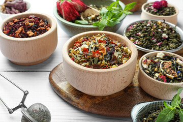 Many different herbal teas on white wooden table